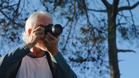 Senior-man-clicking-photos-with-digital-camera-4k
