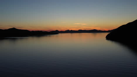 aerial advance view of calm ocean at sunset, beautiful evening sky with reflected in calm sea water