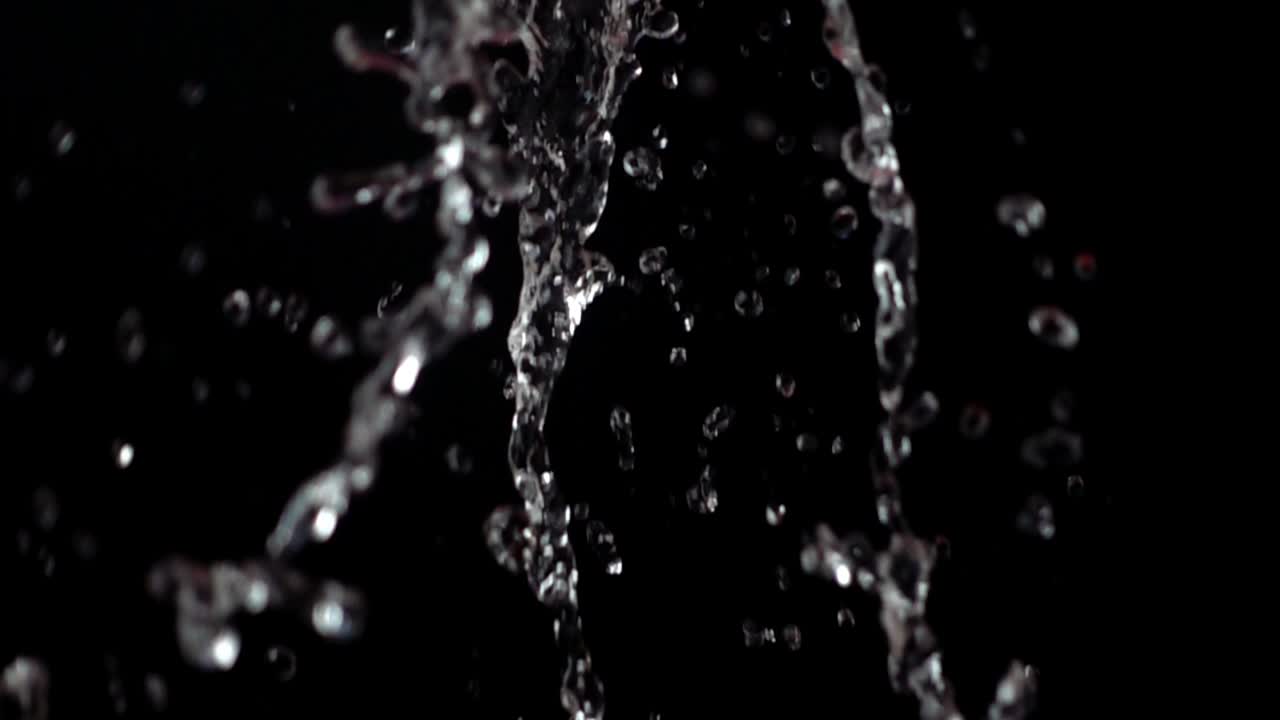 Water on a black background. Slow motion