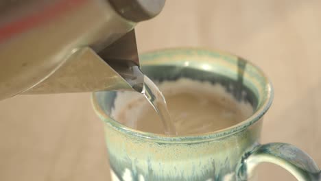 pouring coffee into a mug