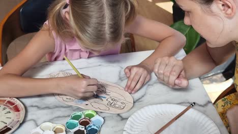 mother and daughter painting together