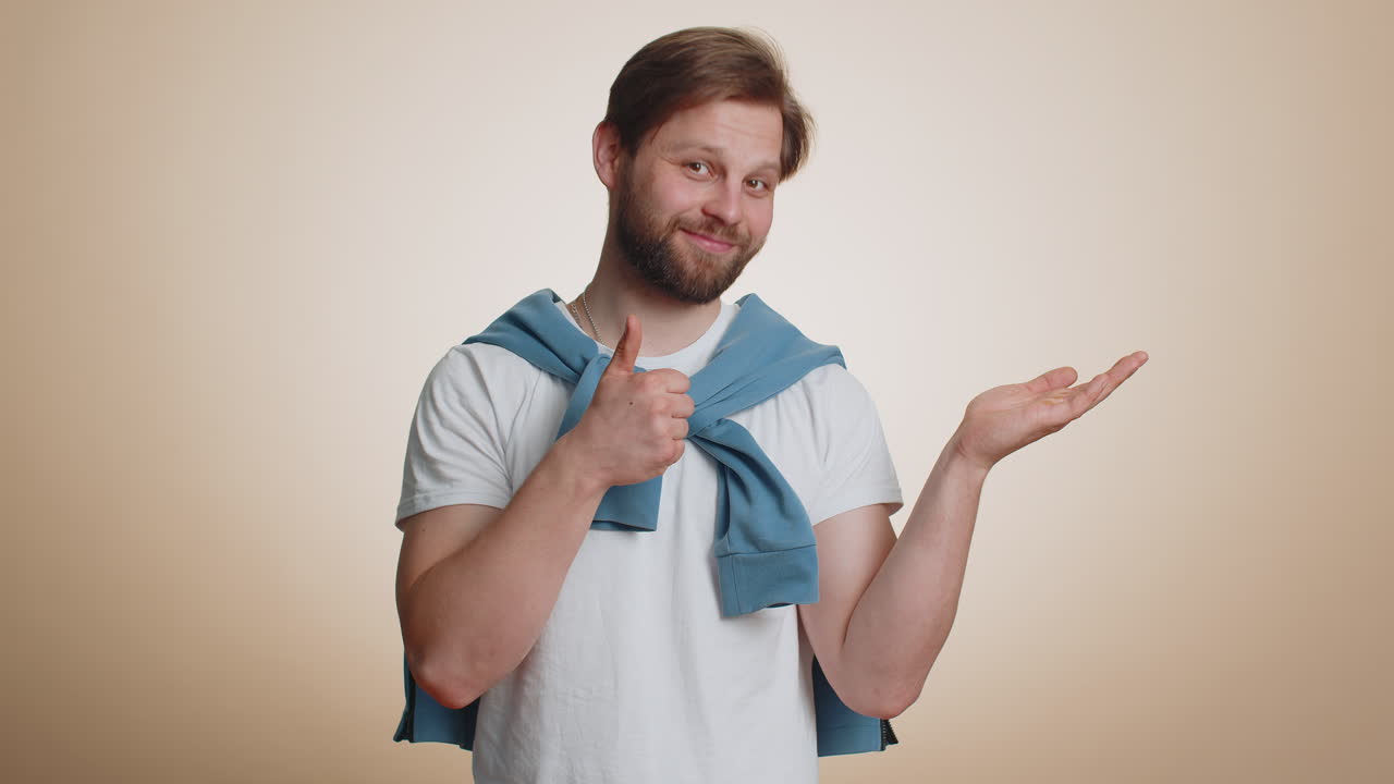 Caucasian man showing thumbs up pointing at right on blank space place for your advertisement logo