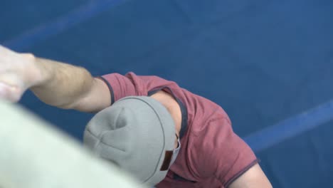 rock climber climbing an indoor rock wall using athletic chalk for grip-7