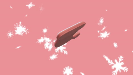animación de navidad santa sombrero galleta de pan de jengibre sobre la nieve cayendo sobre fondo rosa