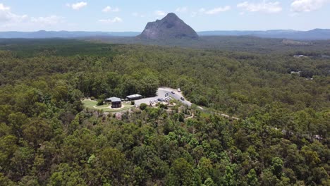 Aerial-view-of-forest-and-flying-over-a-lookout-towards-a-mountain