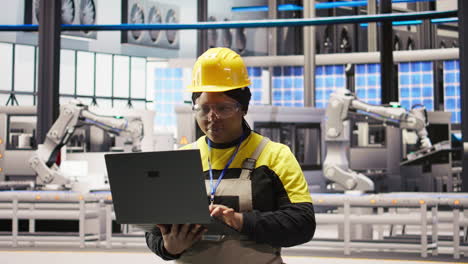 vertical video smart factory engineer using laptop to implement automated workflows