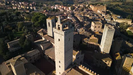drone orbiting above medieval tower in san gimignano, italy