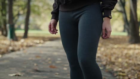 ginger woman warming up and start running at the park in autumn