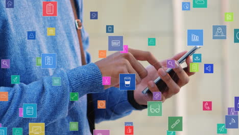 Animación-De-Múltiples-íconos-Digitales-Flotando-Contra-La-Sección-Media-De-Un-Hombre-Usando-Un-Teléfono-Inteligente.