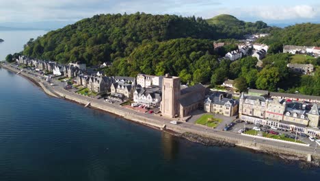 st columba's cathedral, oban harbour, seaside town on west coast of scotland, aerial drone 4k hd footage rotating