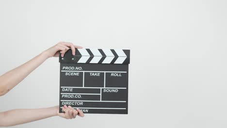 close up female hold making movie production clapperboard on white background.