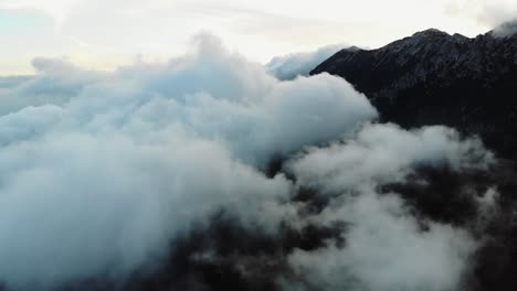 soar above a tranquil mountain trail as gentle clouds drift across the sky