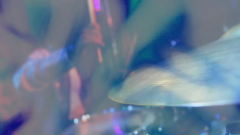 drummer hitting cymbal on live music stage, with animated soundwave overlay pulsing