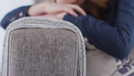 close up view of woman lying on the couch at home