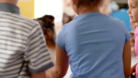 rear view of kids having fun with therapy dog