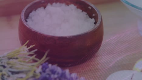 animation of glitter over bowls with scrub, flowers and candle