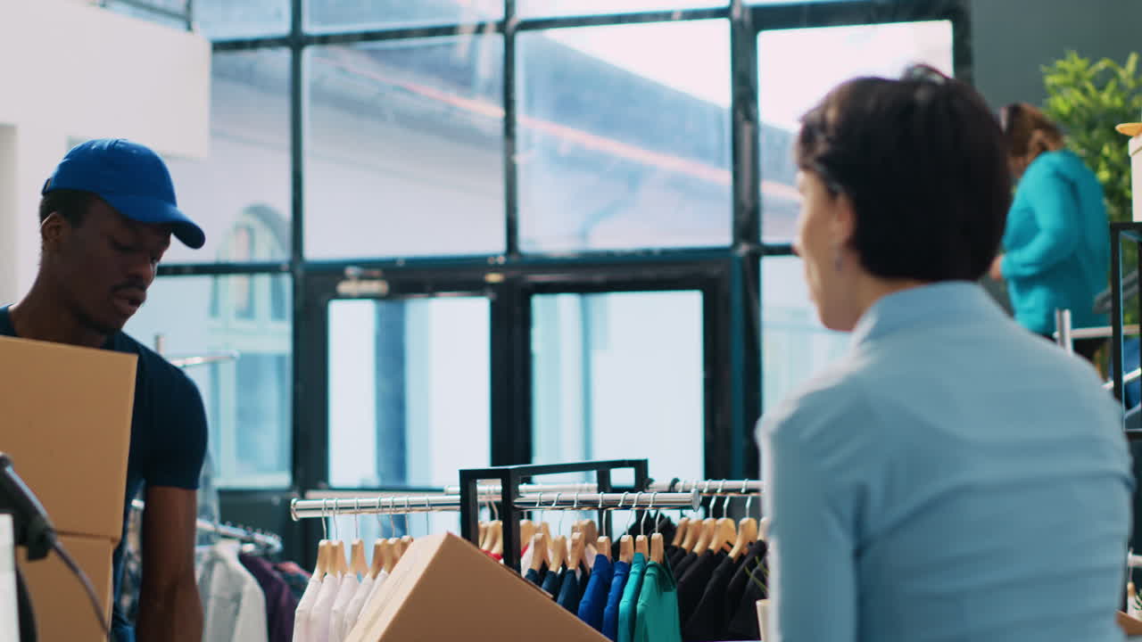 Courier carrying cardboard carton,