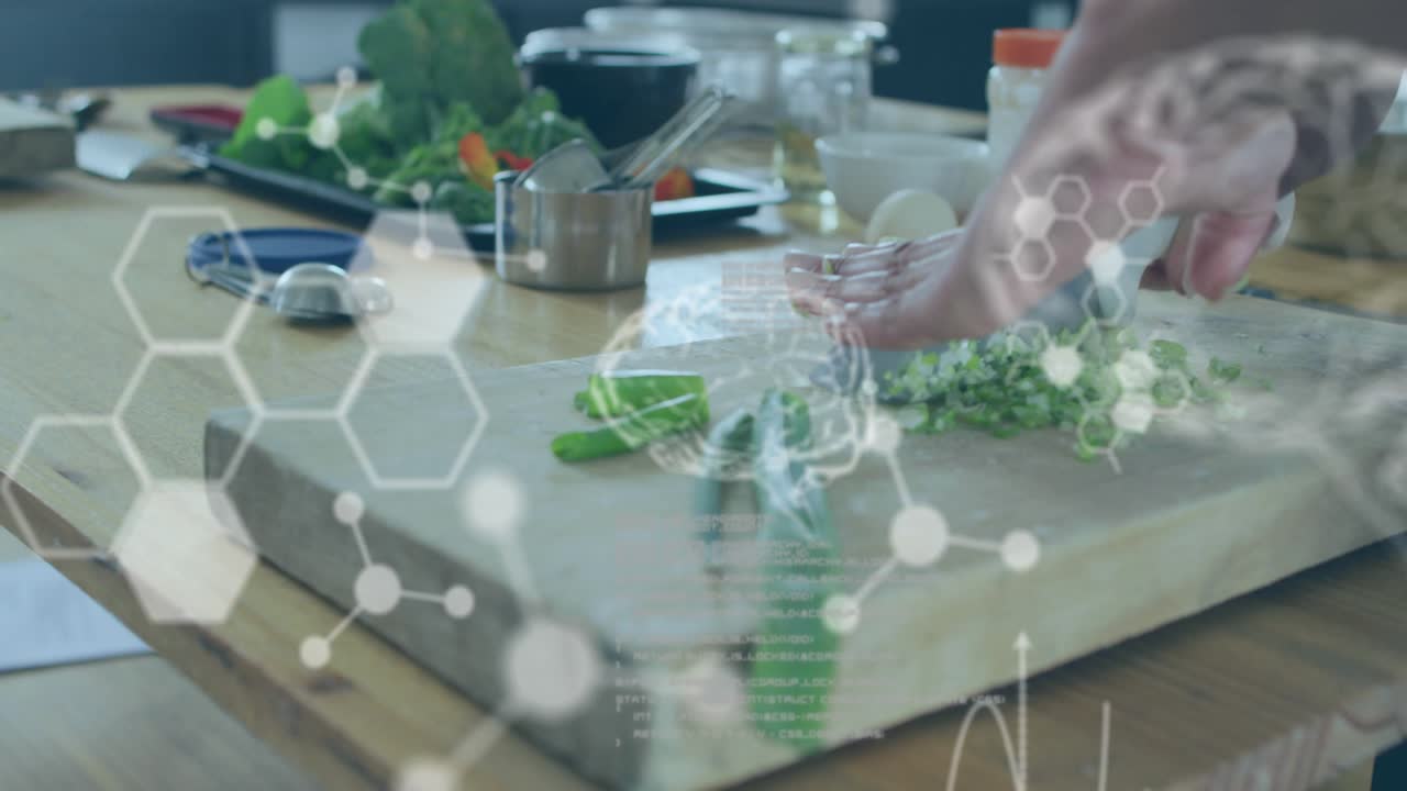 Woman's hand entering, slicing greens with knife on board while code graphics showing food science