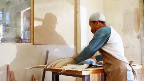 surfboard maker working in workshop 4k