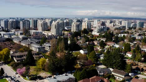 Cars-Driving-In-The-Streets-Of-Community-In-Richmond-City-Near-The-High-rise-Buildings-In-BC,-Canada