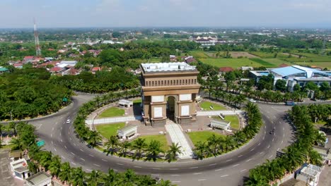 Iconic-Simpang-Lima-Gumul-Monument-in-Kediri-Indonesia,-aerial-view-in-sunny-day