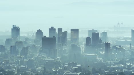vista general del paisaje urbano con múltiples edificios modernos y astilleros cubiertos de smog