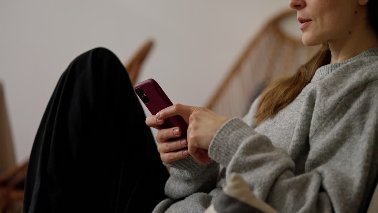 женщина, использующая смартфон дома