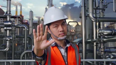 Engineer Gesturing Stop at Industrial Plant