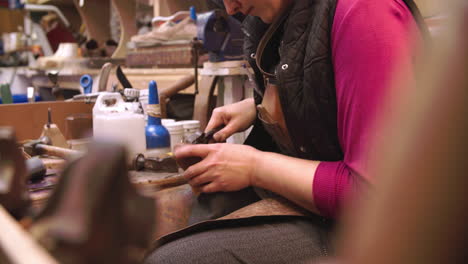 Bespoke-Shoemaker-Pinning-Leather-Together-To-Make-Shoe