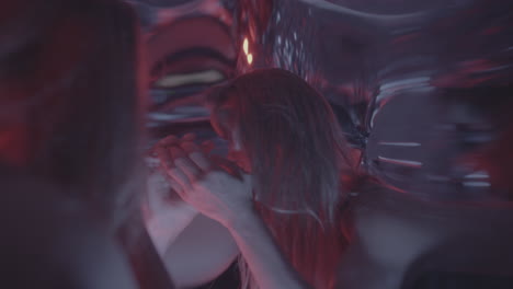 captivated woman dancing beside distortion mirror during artistic performance
