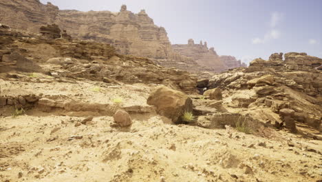 rocky landscape showcasing barren terrain in a desert region under blue sky