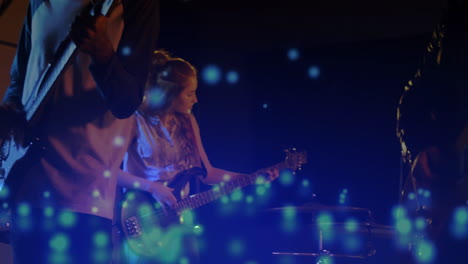bandmates performing on concert stage, projecting blue light overlays for music industry showcase