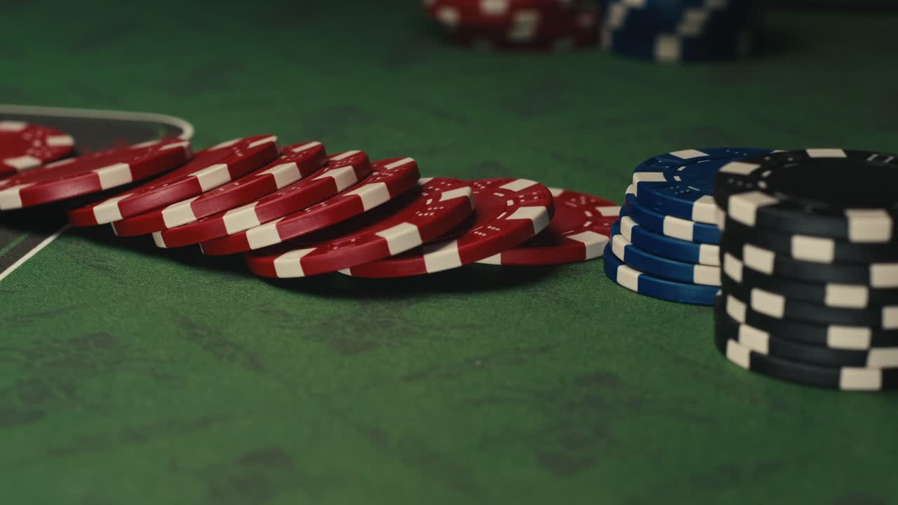 Poker chips on a green casino table
