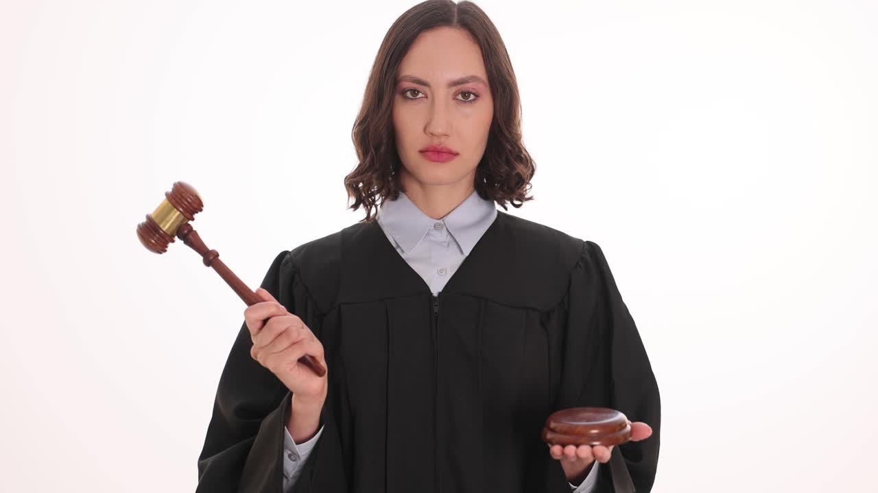 Female Judge Holding Gavel and Sounding Block