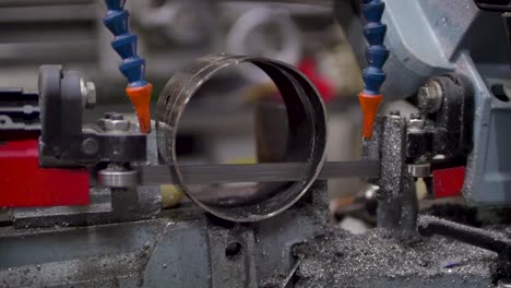 Cutting-steel-tube-by-industrial-saw-machine,-slow-motion