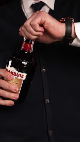 opening a bottle of drambuie