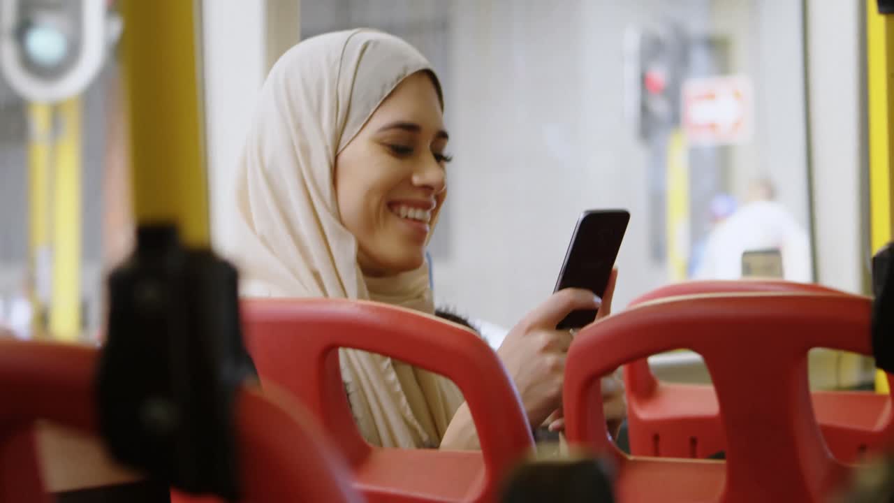 Woman in hijab using mobile phone 4k
