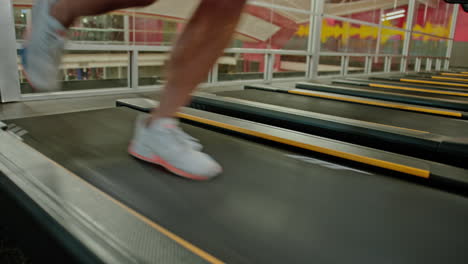 man exercising on treadmills, doing fitness exercise