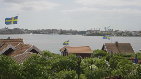 swedish cottages displaying national pride with waving flags