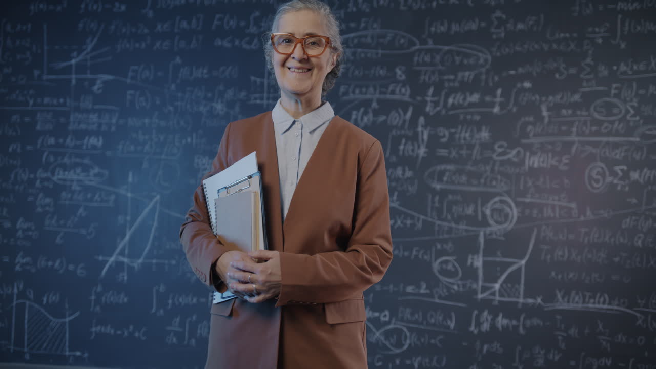 Professor in front of a chalkboard with equations