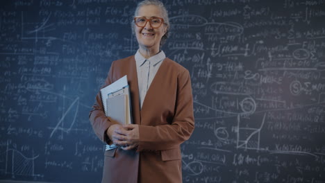 professor in front of a chalkboard with equations