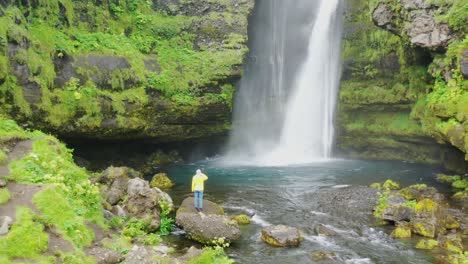 woman in front of a waterfall in iceland