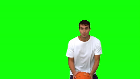 Man-catching-and-throwing-a-basketball-on-green-screen