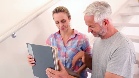 Happy-couple-choosing-a-carpet