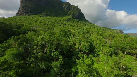 drone flying fast from the beach revealing the landmark le morne brabant in mauritius