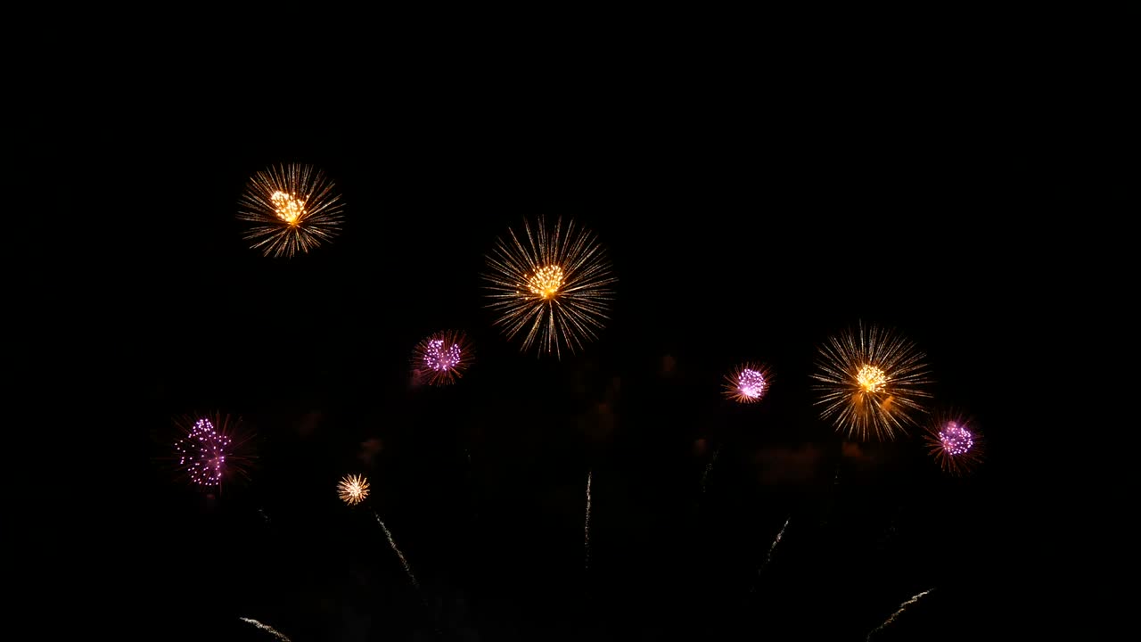 4K. loop seamless of real beautiful fireworks background during new year's eve countdown celebration, real golden shining fireworks festival in the sky at night with colorful. glowing fireworks show.