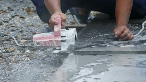 man cutting granite stone