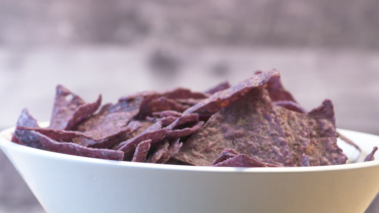 Appetizing bowl of crunchy, blue corn nachos
