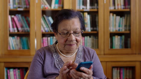 Elderly-woman-on-her-phone-in-a-library