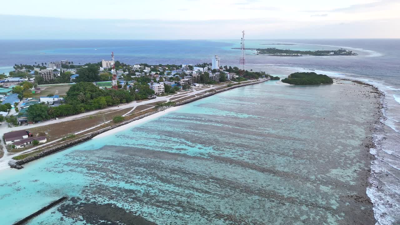 Ripresa aerea con drone di Thulusdhoo, Maldive, isola tropicale esotica remota, barriera corallina, sabbia bianca, acqua turchese, Atollo di Kaafu